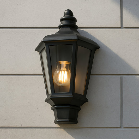 Black outdoor wall light fixture on a light gray siding wall
