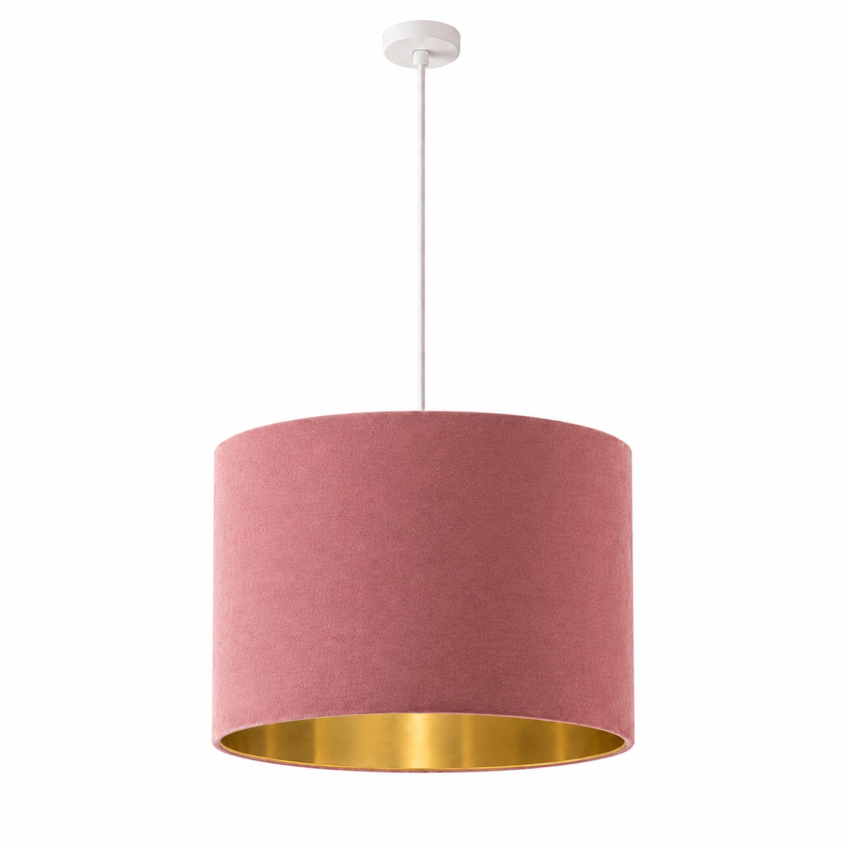 A pink fabric drum pendant light with a gold interior, hanging from a white cord against a gray paneled wall.