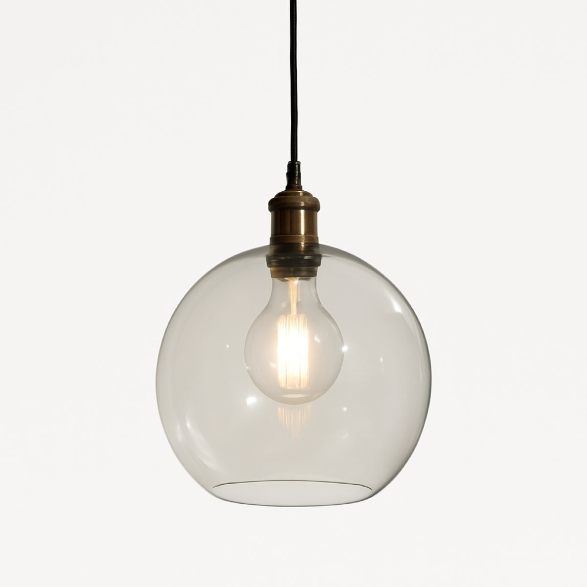 Clear glass pendant light with a visible bulb on a white background