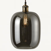 Smoked glass pendant light with brass fixture on a white background