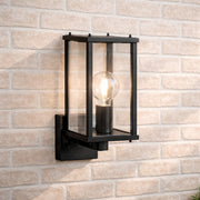 Black outdoor wall light fixture on a brick wall