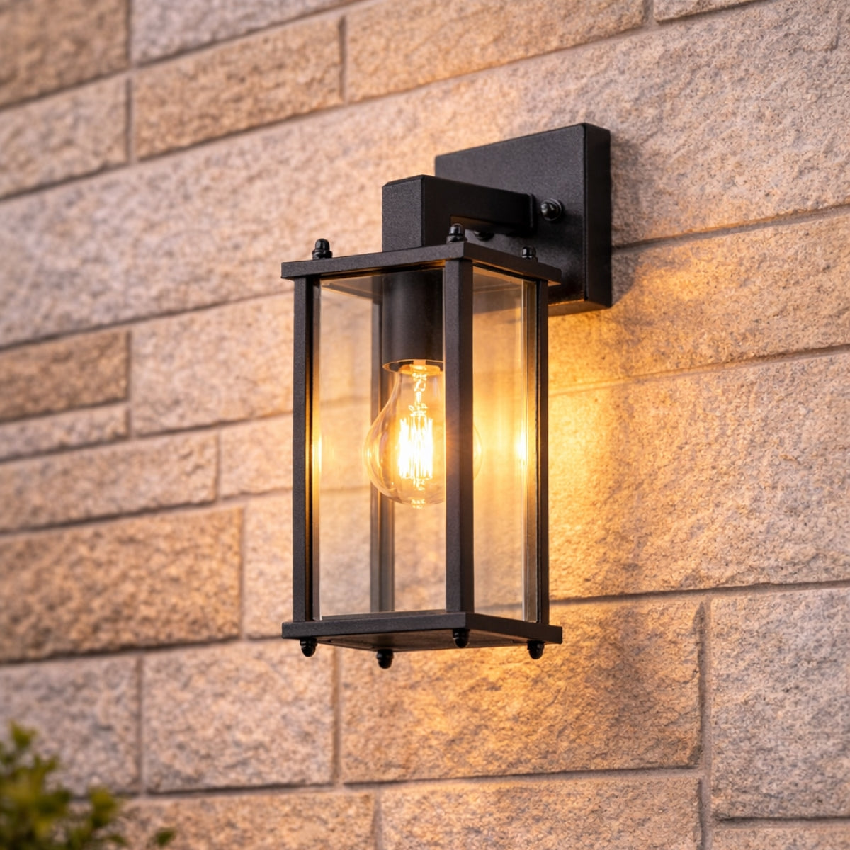 Black outdoor wall light fixture on a stone wall