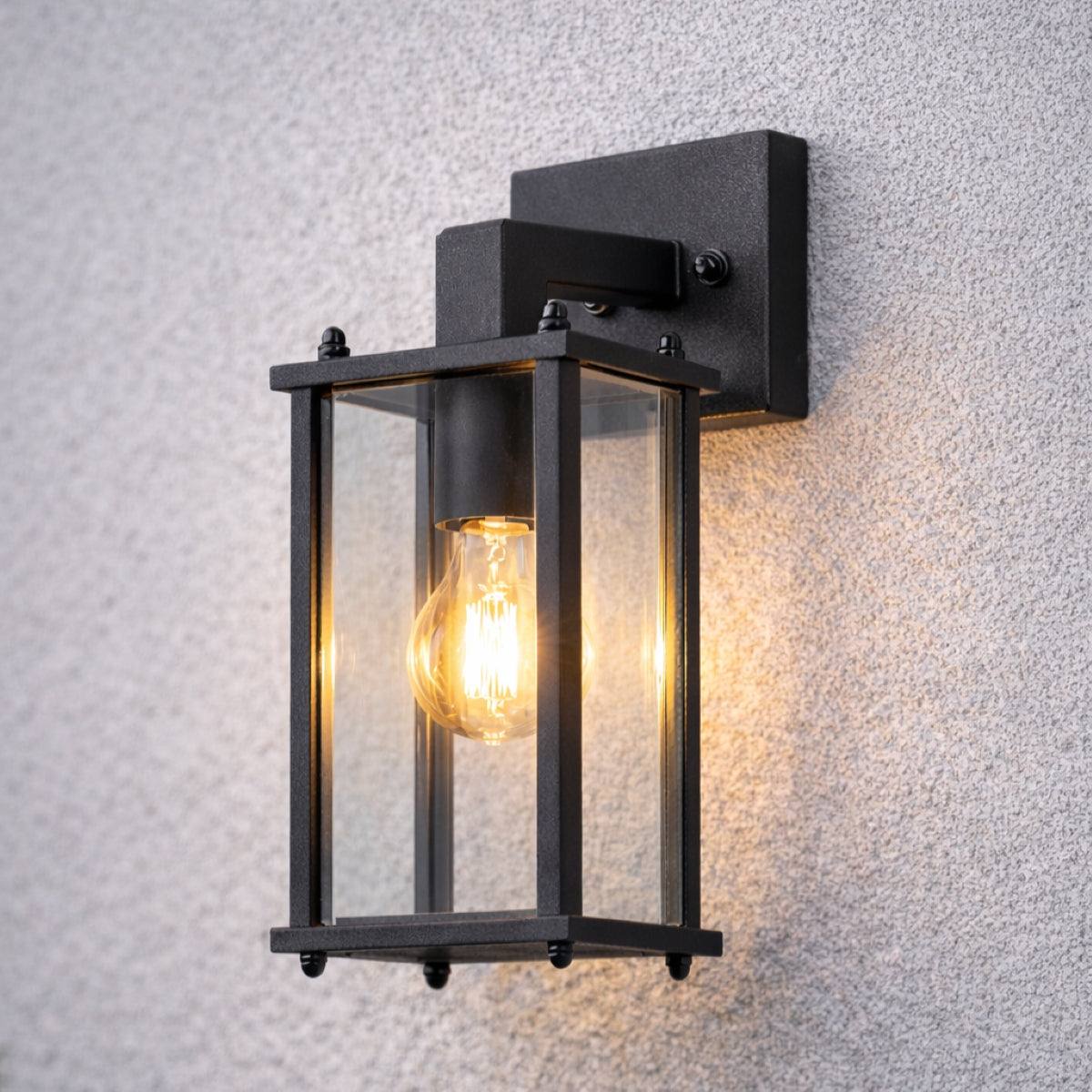 Black outdoor wall light fixture on a textured gray wall