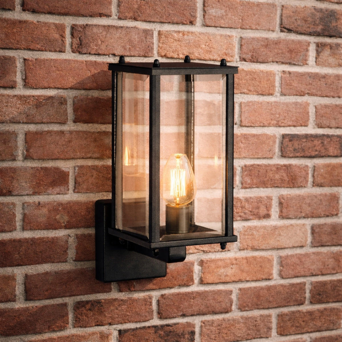 Black outdoor wall light fixture on a brick wall