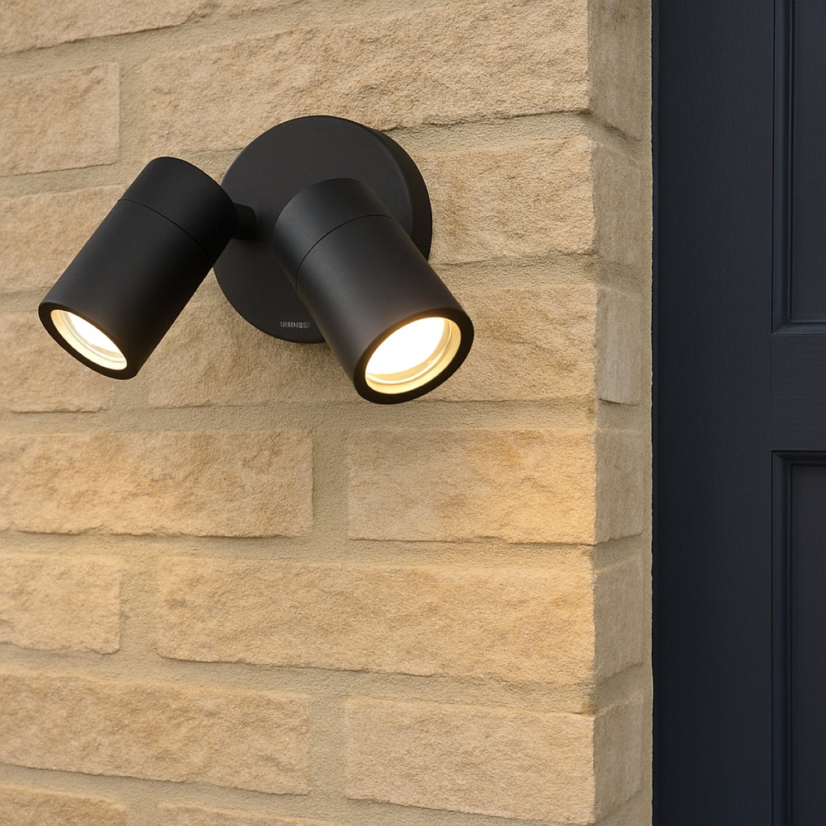 Black outdoor wall light fixture on a stone wall