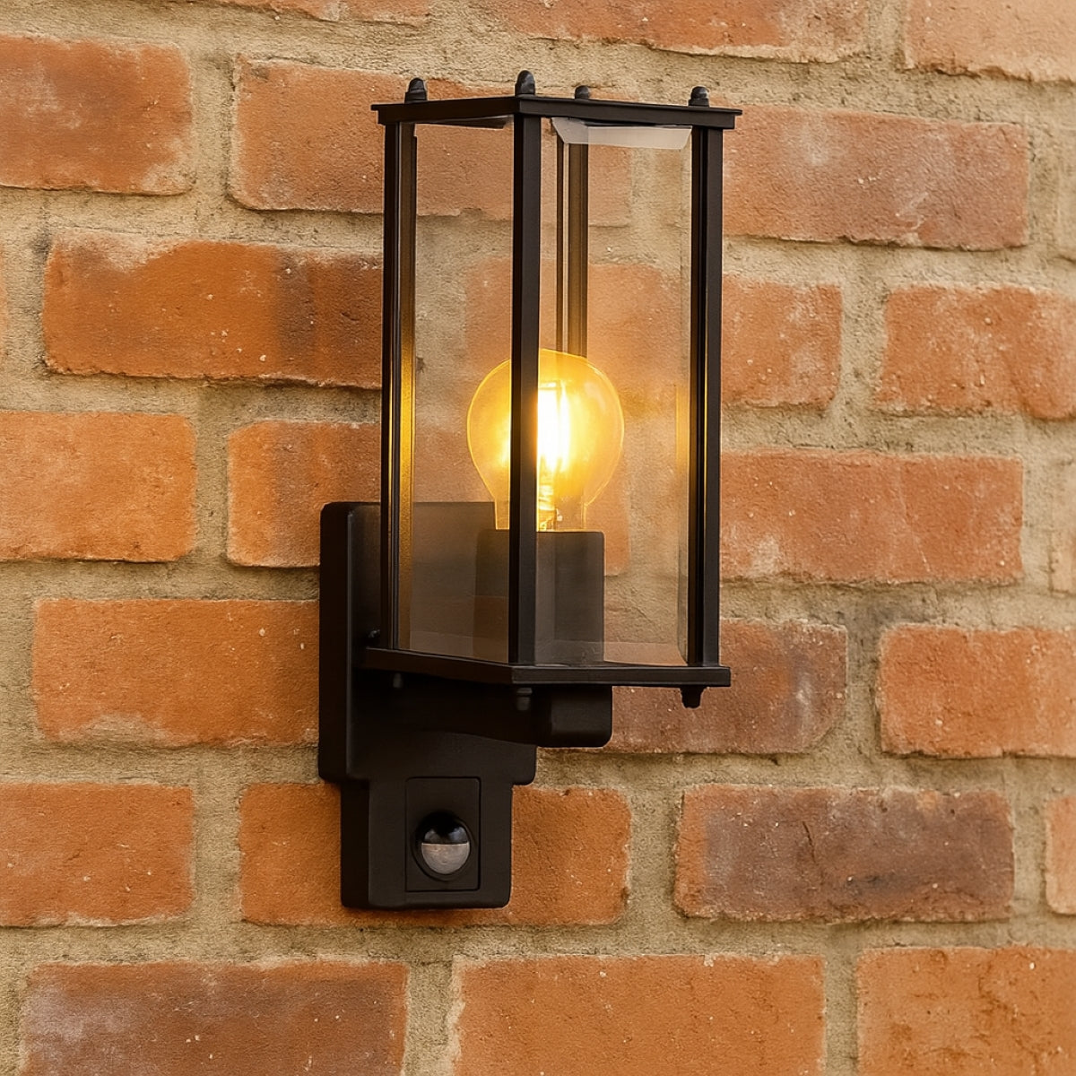 Black outdoor wall light fixture on a brick wall