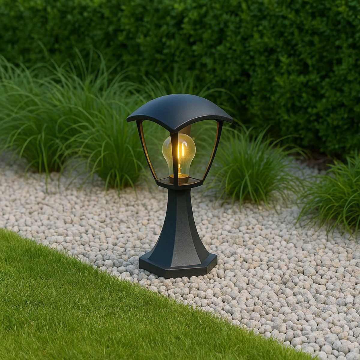 Black outdoor lamp with a lit bulb on a gravel path surrounded by greenery