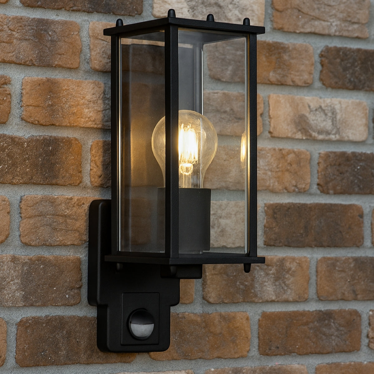 Black outdoor wall light fixture on a brick wall
