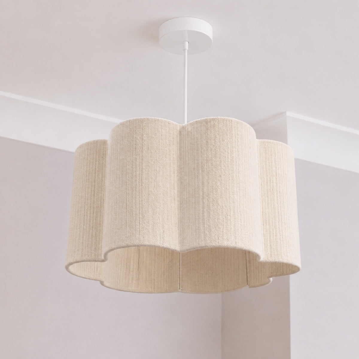Beige scalloped pendant light fixture on a white ceiling