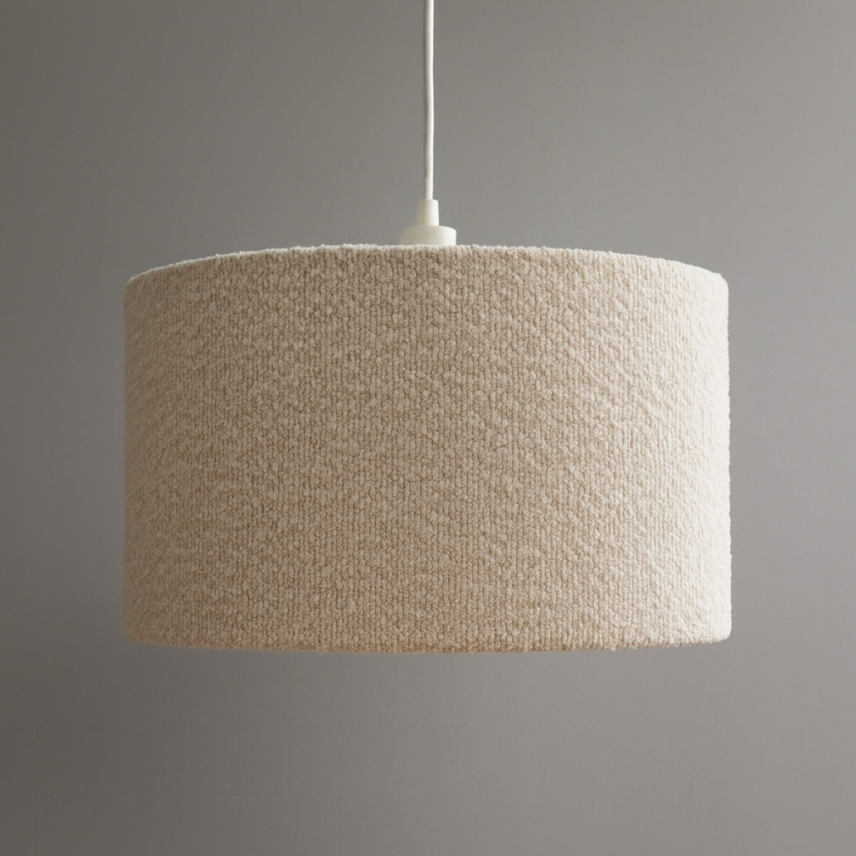 Textured beige pendant lamp on a gray background