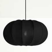 Black pendant lamp with a ribbed texture on a white background