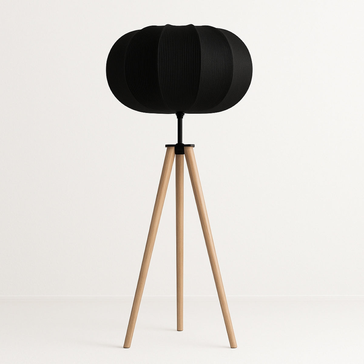 Black spherical lamp on a wooden tripod stand against a white background