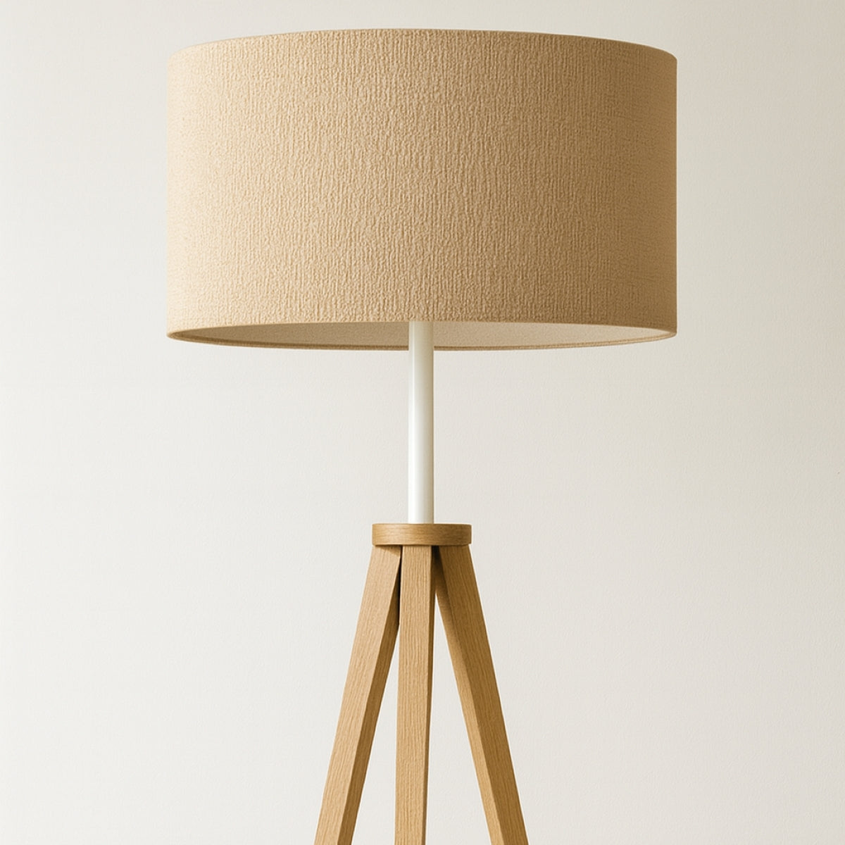 Floor lamp with a beige lampshade and wooden base on a light background