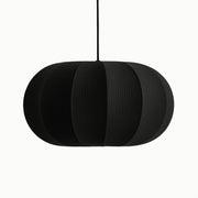 Black pendant lamp with a ribbed texture on a white background