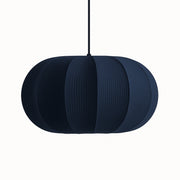 Dark blue pendant lamp with a textured surface on a white background