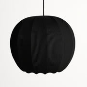 Black pendant lamp with ribbed texture on a white background