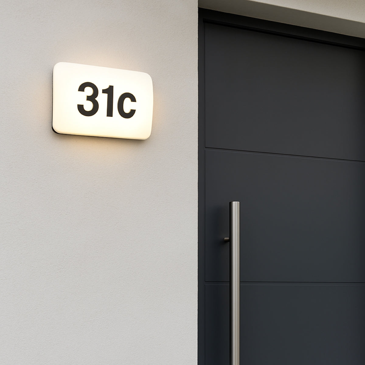 Modern house number '31c' on a wall next to a dark door.