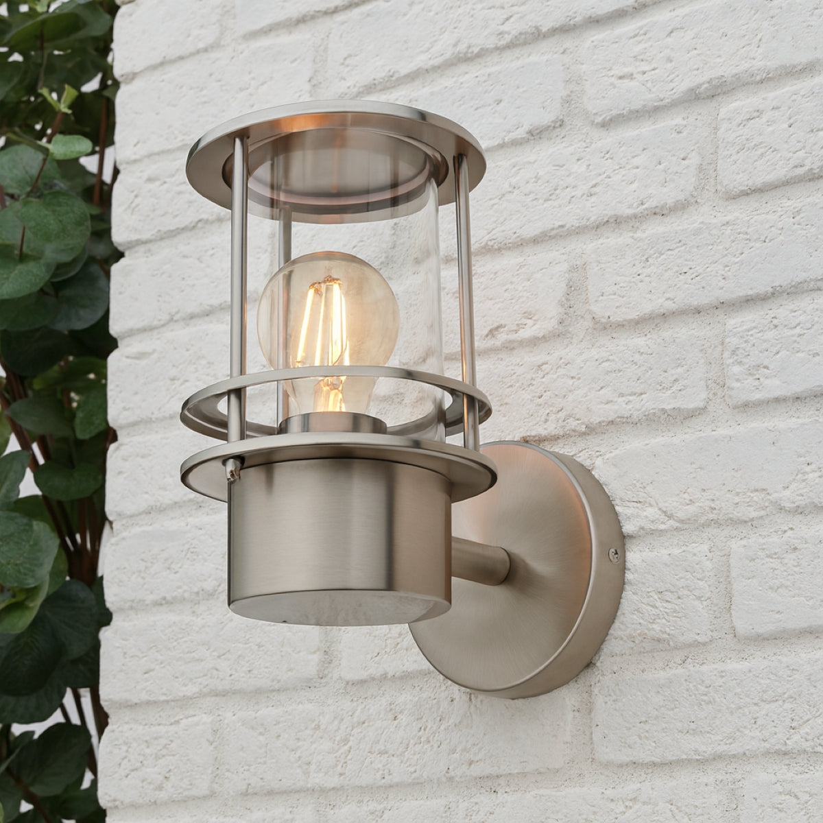 Outdoor wall light fixture on a white brick wall