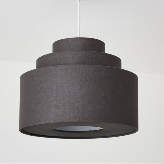Grey tiered pendant light on a white background