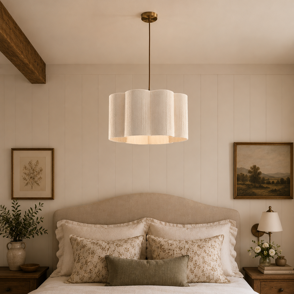 Neatly made bed with decorative pillows in a bedroom setting with a pendant light and wall art.