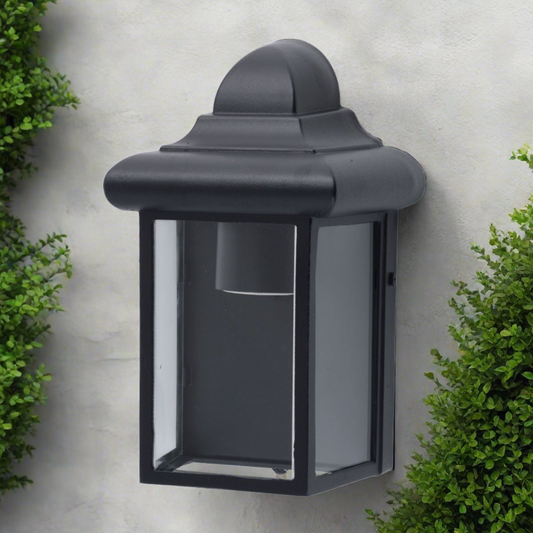 Our Camila wall lantern light is styled with a sophisticated black colour scheme, allowing the wall light to fit into any home’s style. What’s more, the lantern’s design is a modern take on a traditional styled wall light, creating a flexible look for interior and exterior use. 