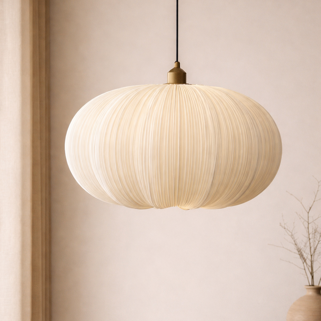 Modern pendant light hanging against a neutral wall with a vase on a shelf.
