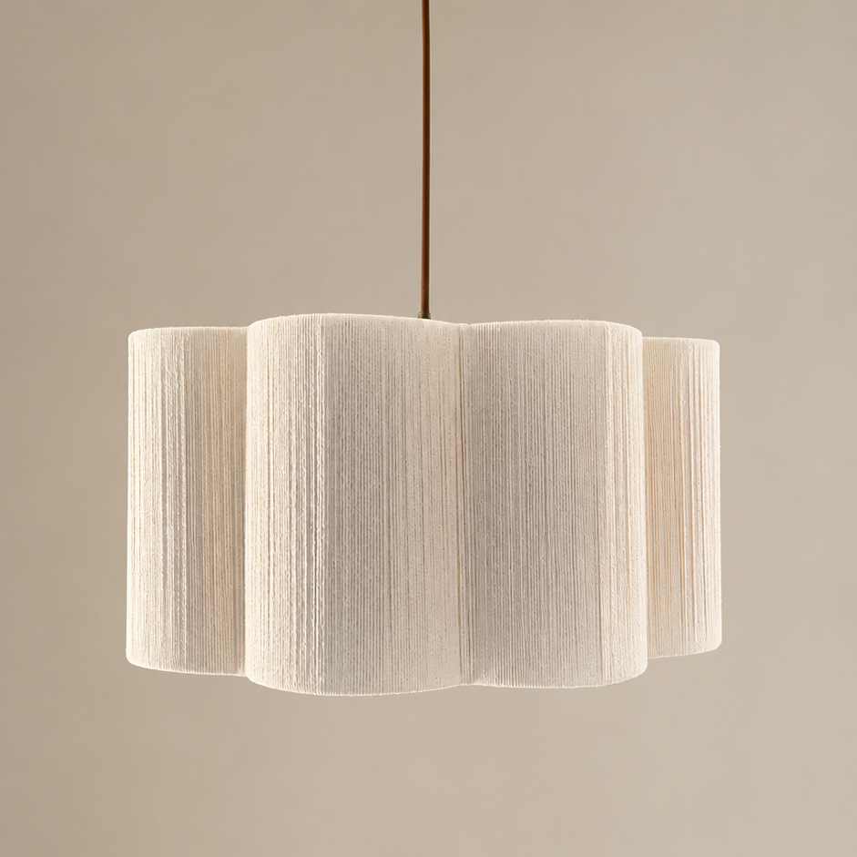 Modern pendant light with a textured white shade and gold fixture on a neutral background