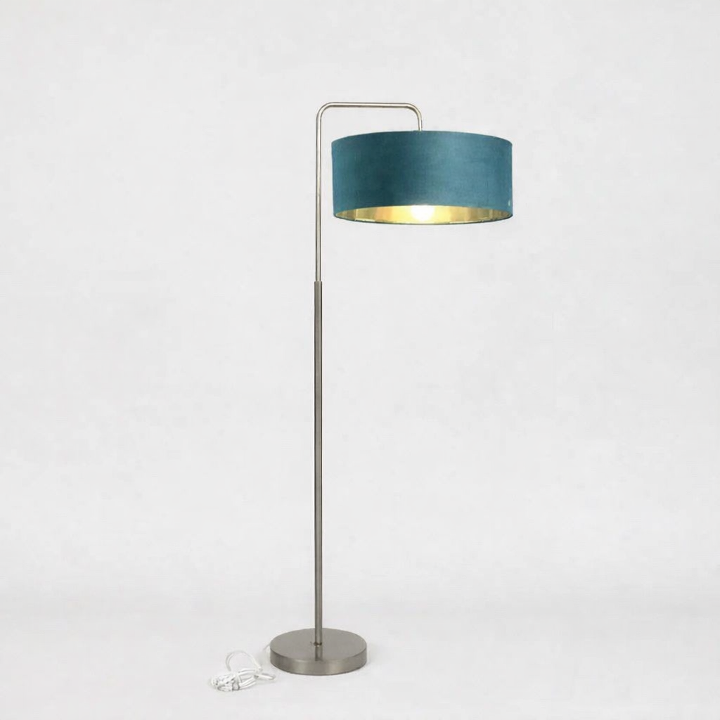 Floor lamp with a teal shade and metal base on a white background