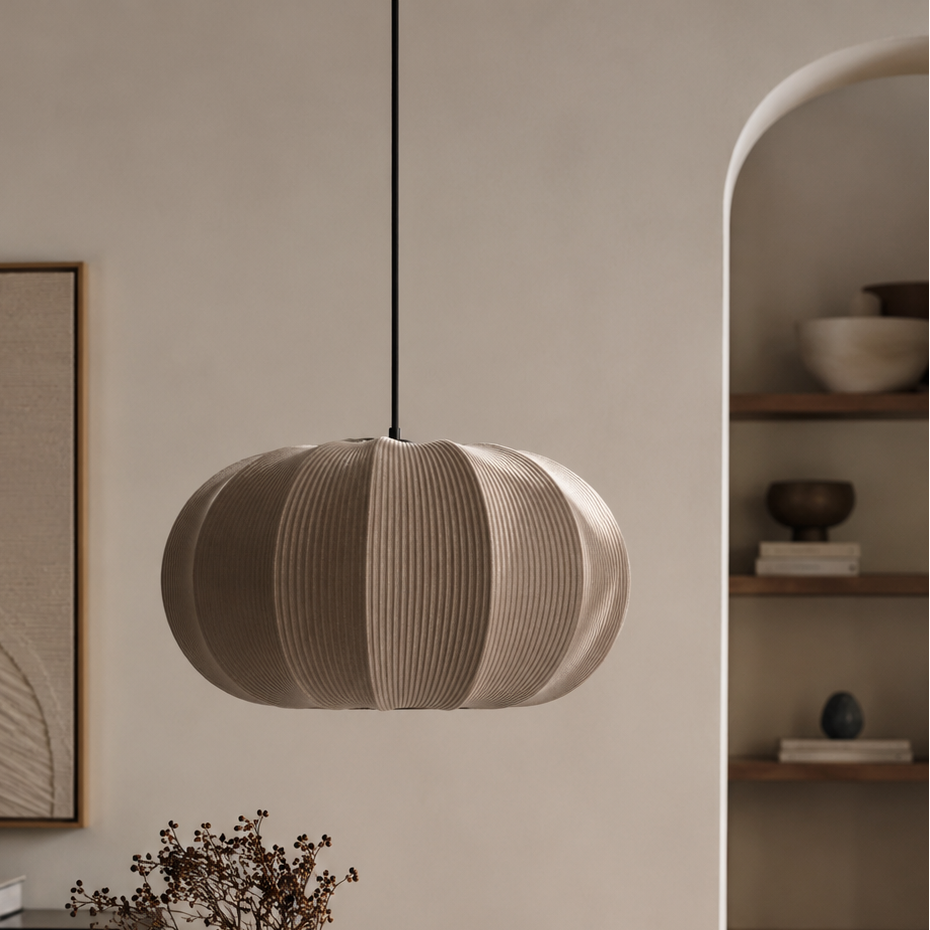 Modern dining room with a round wooden table, pendant light, and minimal decor.