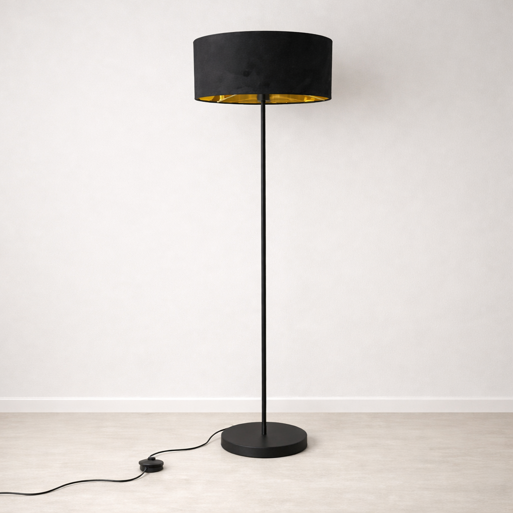 Black floor lamp with a gold interior shade on a white background