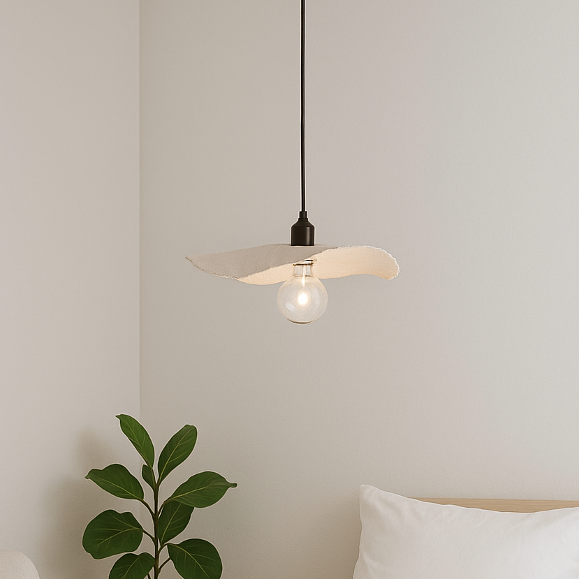 Modern pendant light fixture with a white shade and exposed bulb, hanging against a neutral wall.