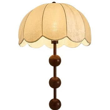 Floor lamp with a decorative brown base and beige lampshade on a white background