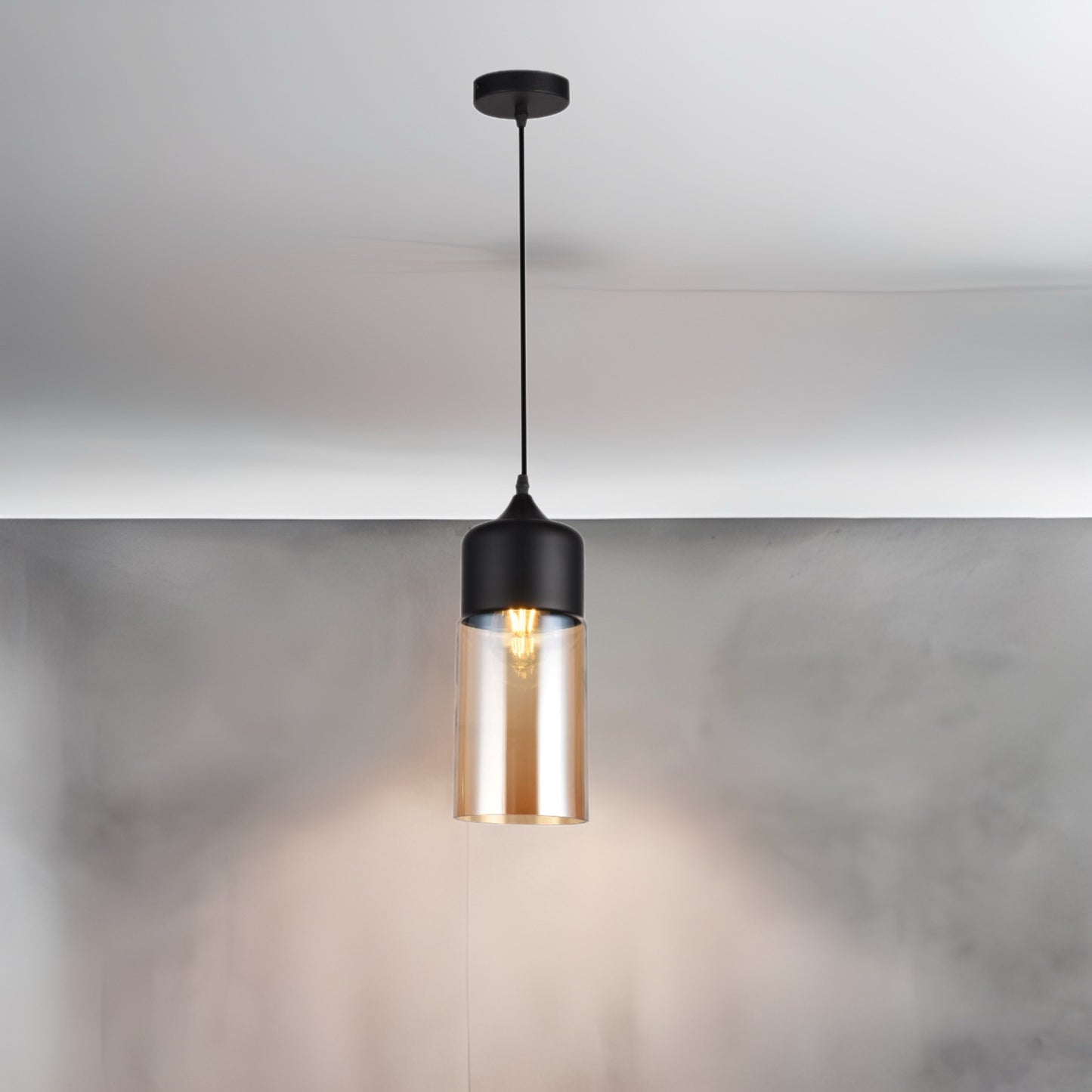 Our Lender pendant light is a stylish addition suitable for every room, its contrasting black and gold smoked glass cylinder body with matching black ceiling rose and cable creates an amazing feature on any ceiling. The lamp looks great with a filament light bulb, especially in industrial and modern interiors.
