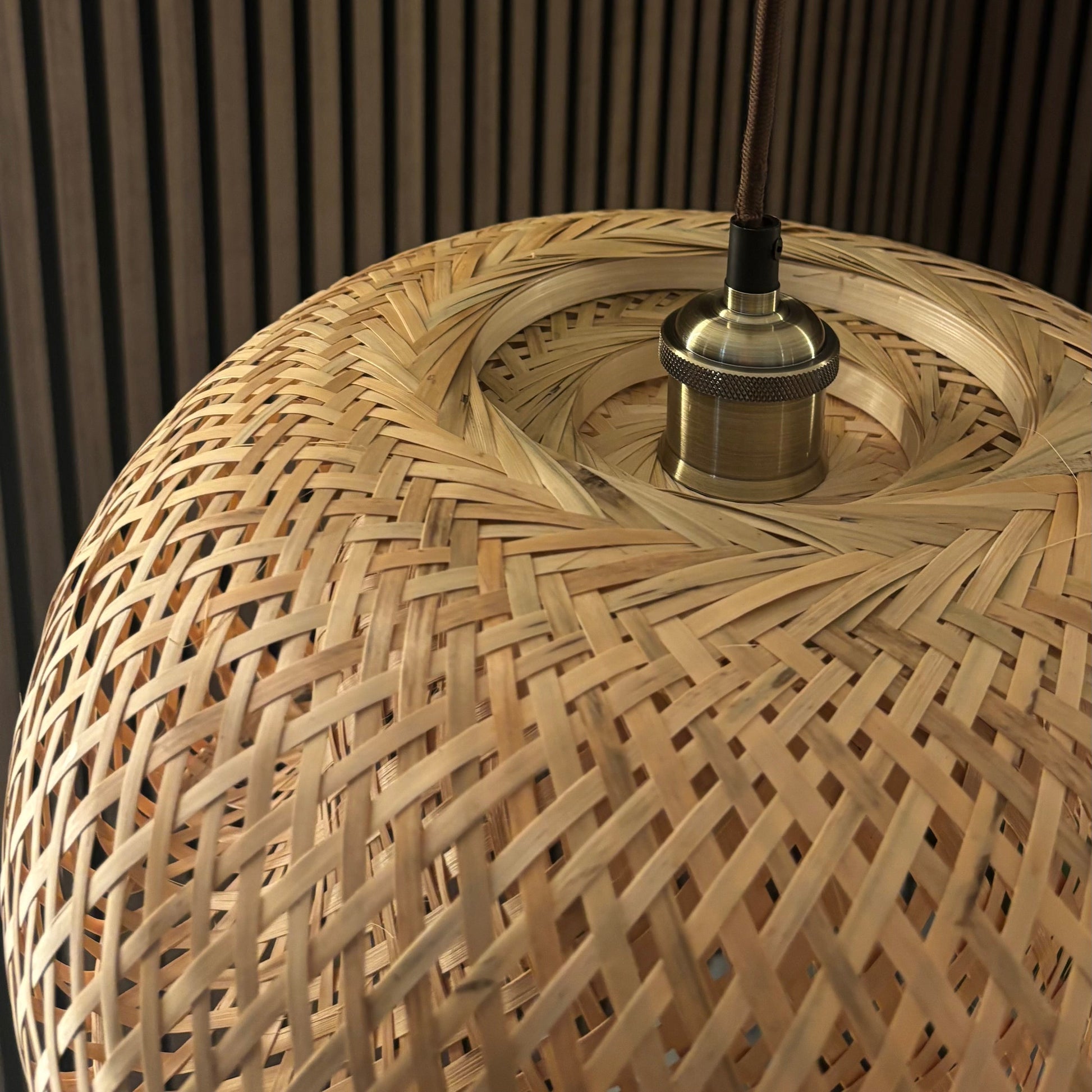 Woven rattan lampshade with a dark background