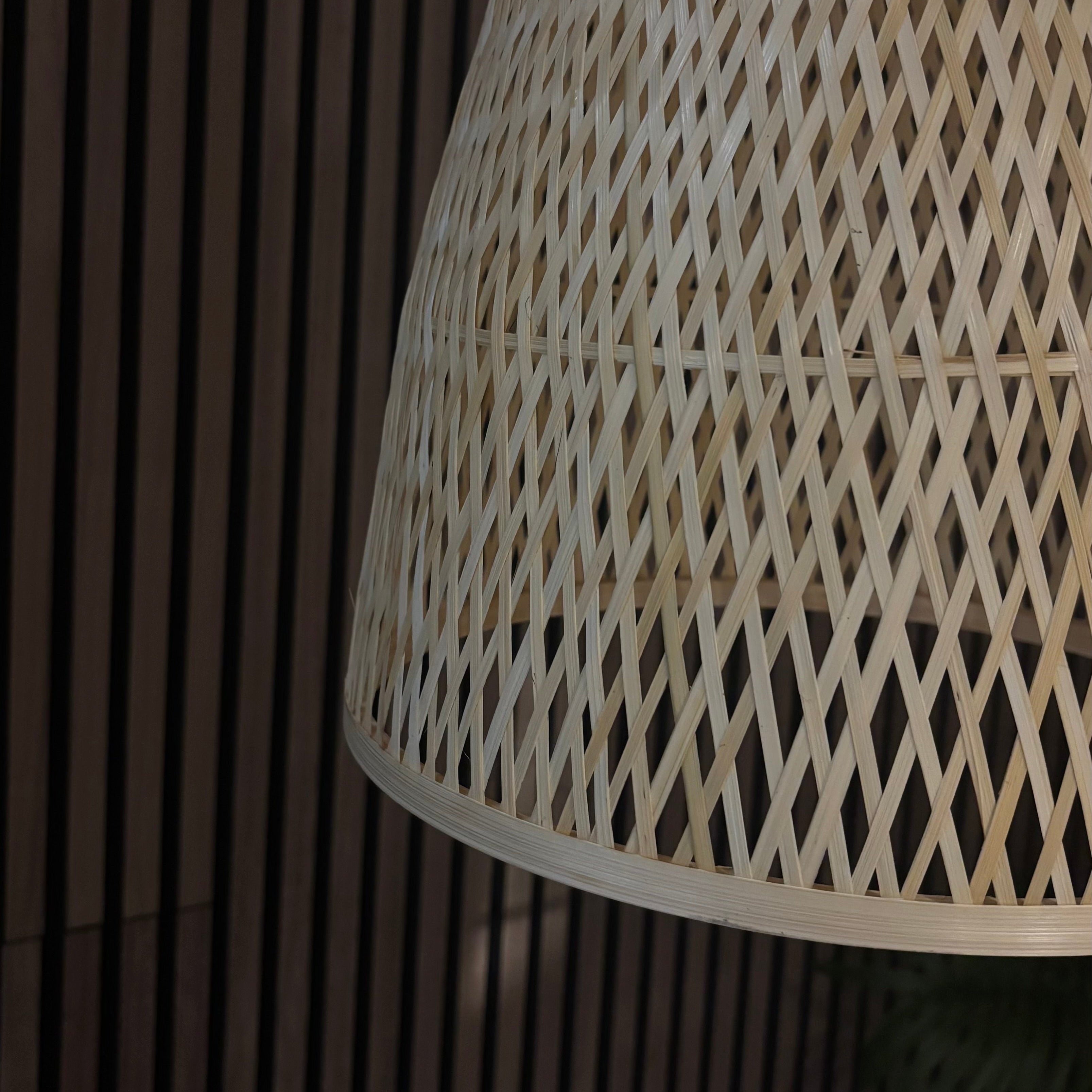 Close-up of a woven lampshade against a dark background