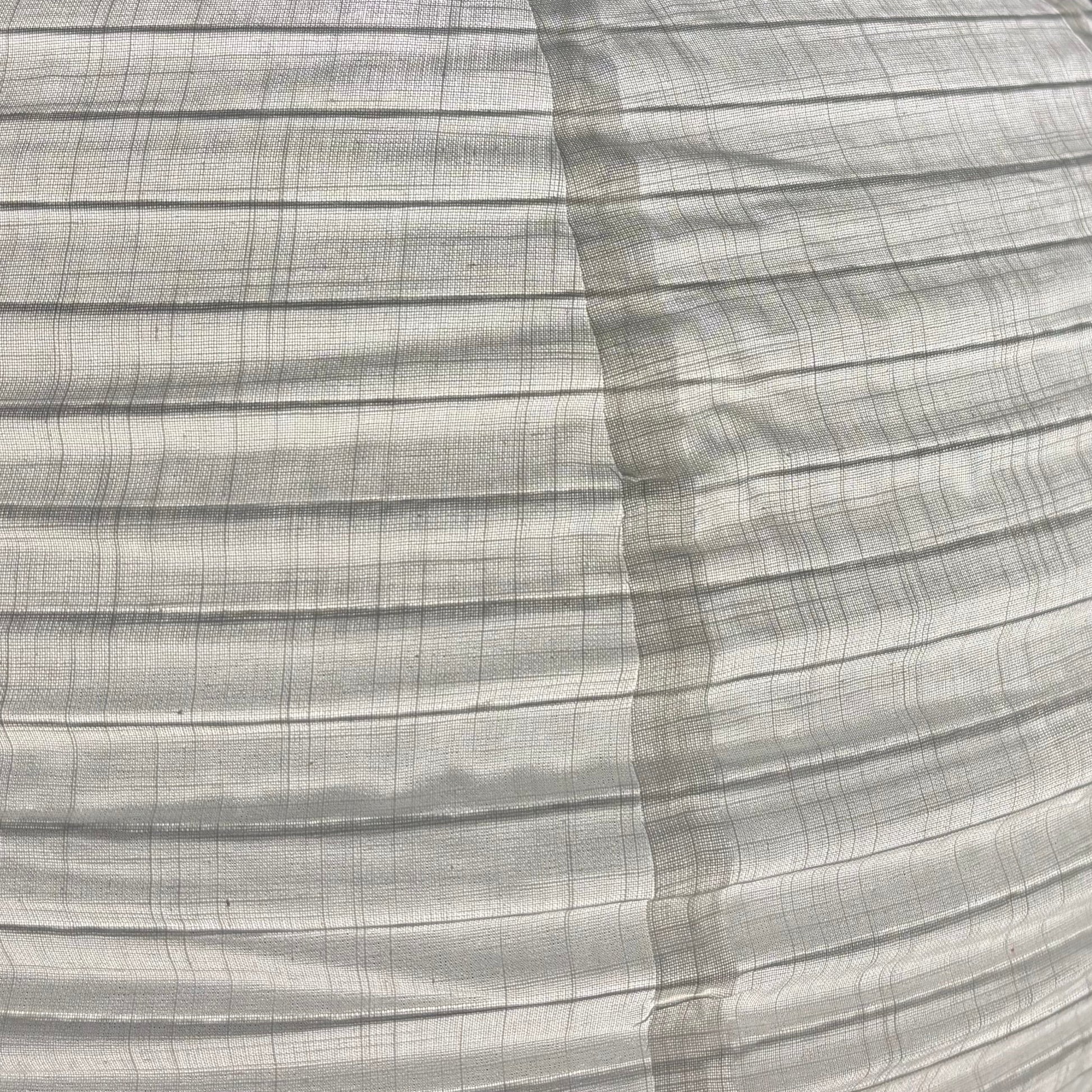 Close-up of pleated fabric with a subtle pattern