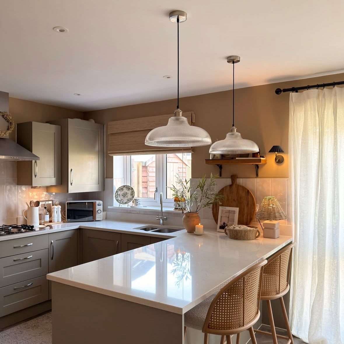 Modern kitchen with white countertops and pendant lights
