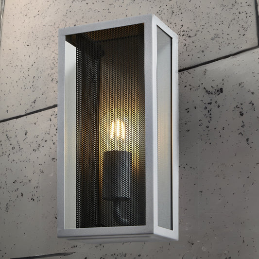 A modern take on a traditional design outdoor wall light perfect for adding style and security The traditional front-door lantern has had a modern make over in the form of our Silas outdoor wall light with its square silver coated metal construction and completed with a black mesh insert and clear windows this light this is sure to add an statement to any wall. 
