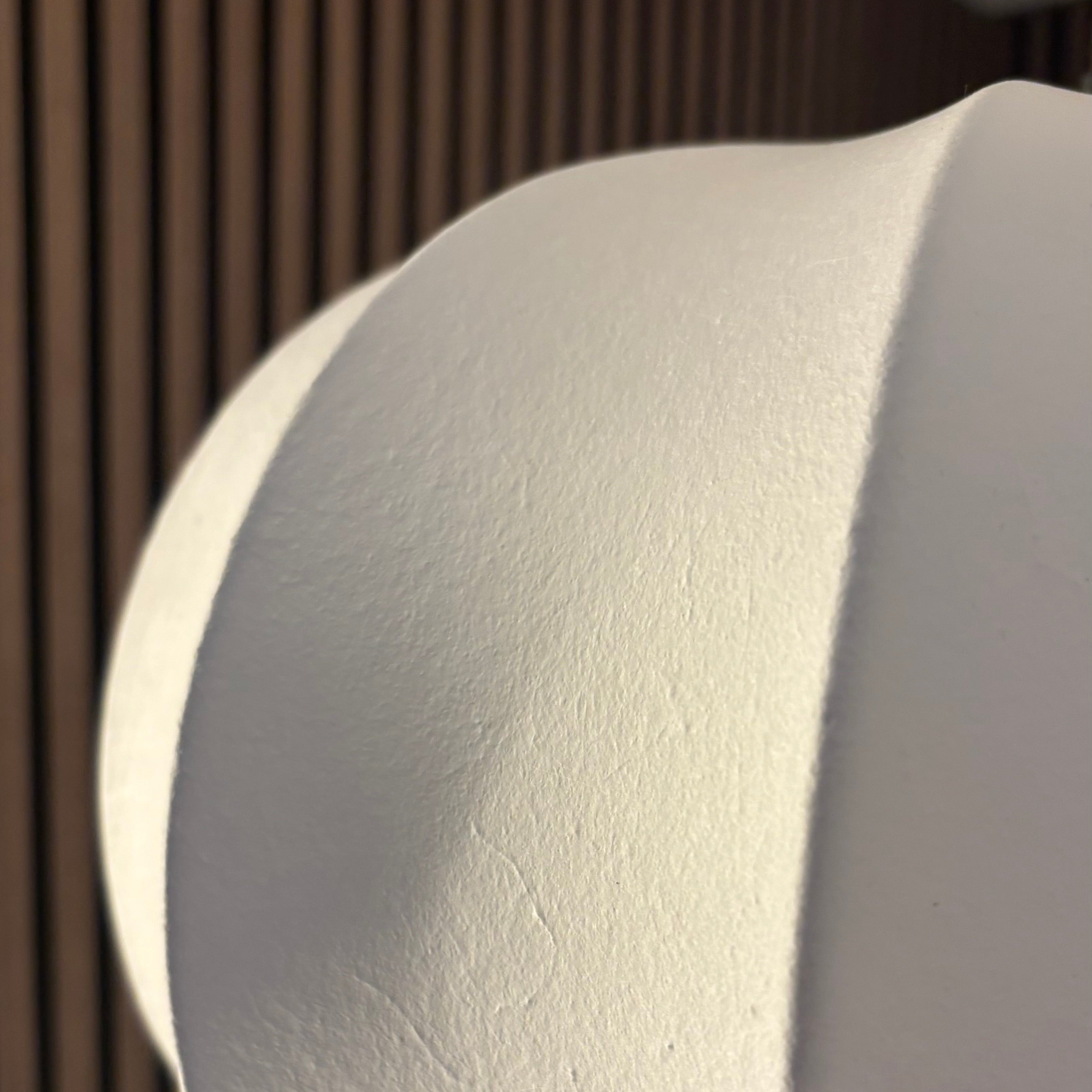 Close-up of a white cylindrical object against a brown wooden background