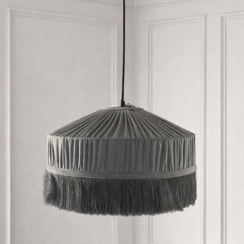 Gray pleated pendant lamp against a white paneled wall