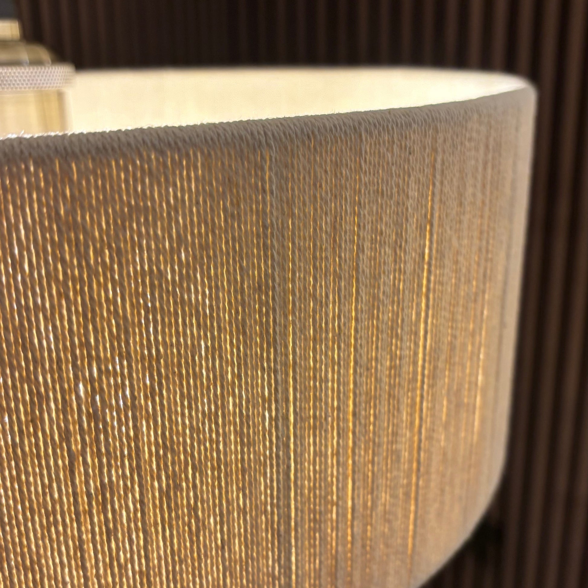 Close-up of a textured brown lampshade with a blurred background