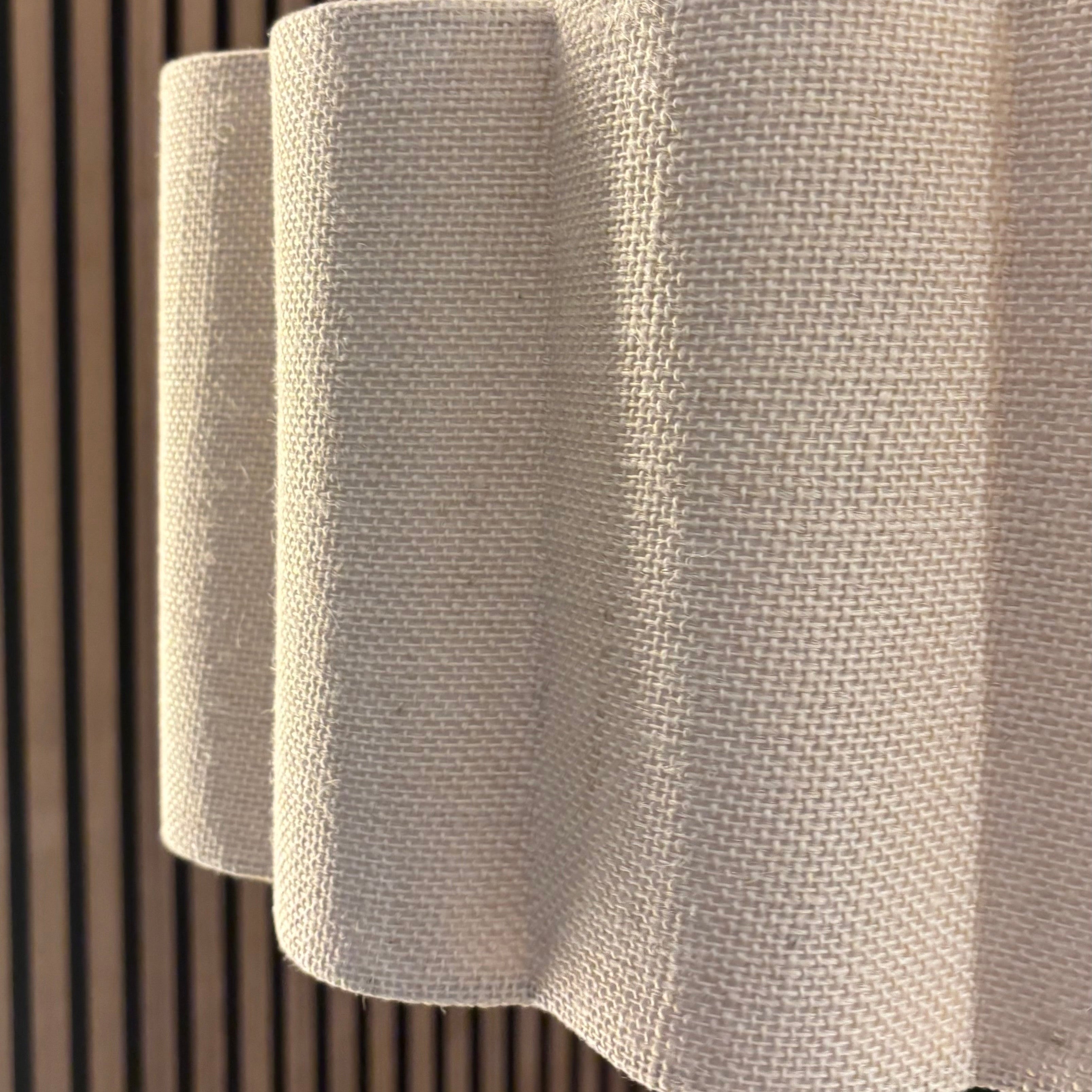 Textured white panel against a wooden slat wall