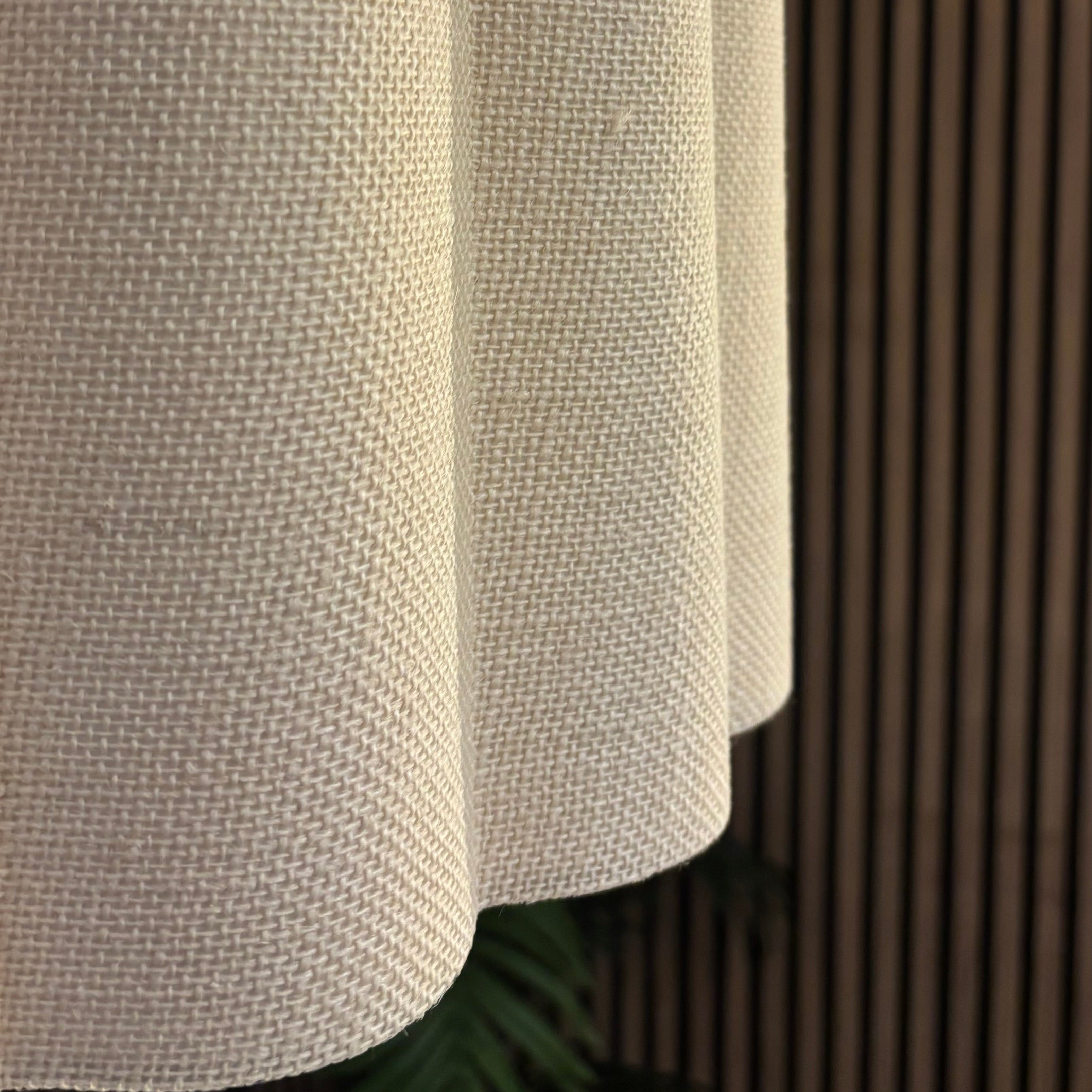 Textured white lampshade against a wooden panel background
