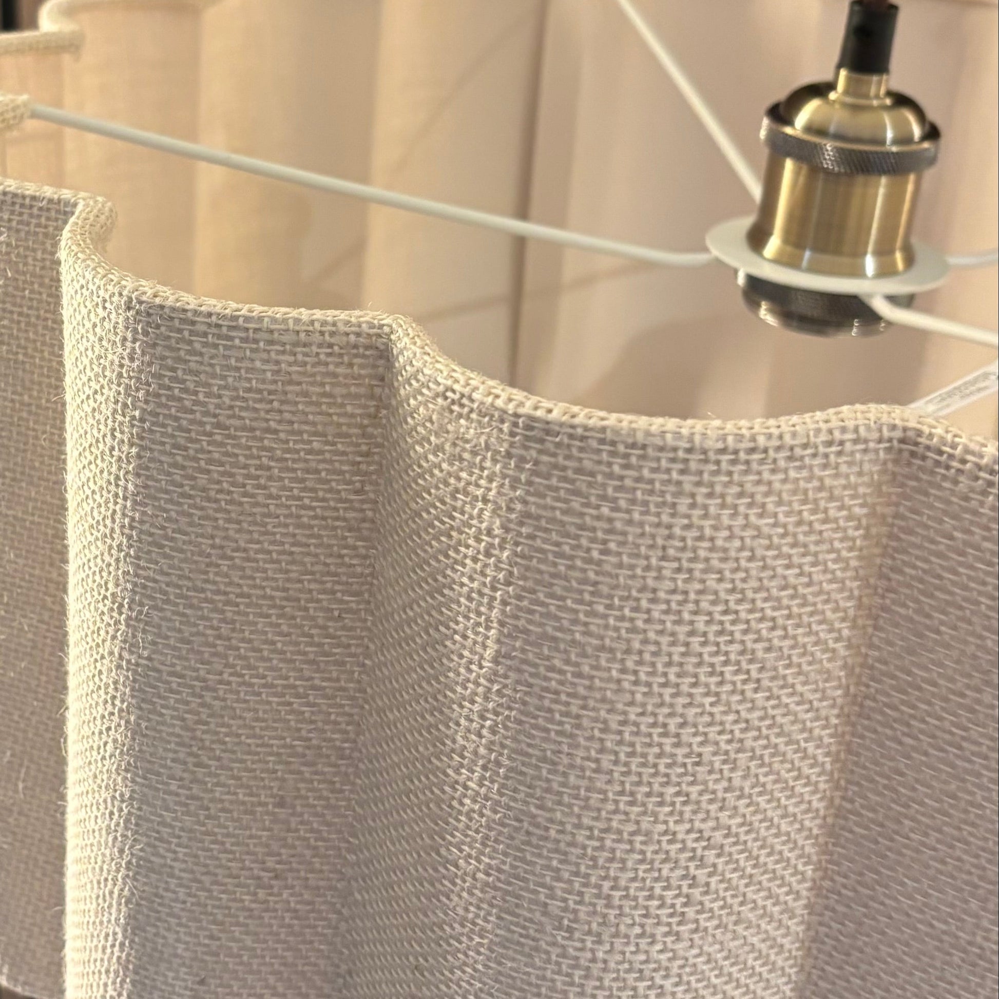 Close-up of a beige textured lampshade with a blurred background