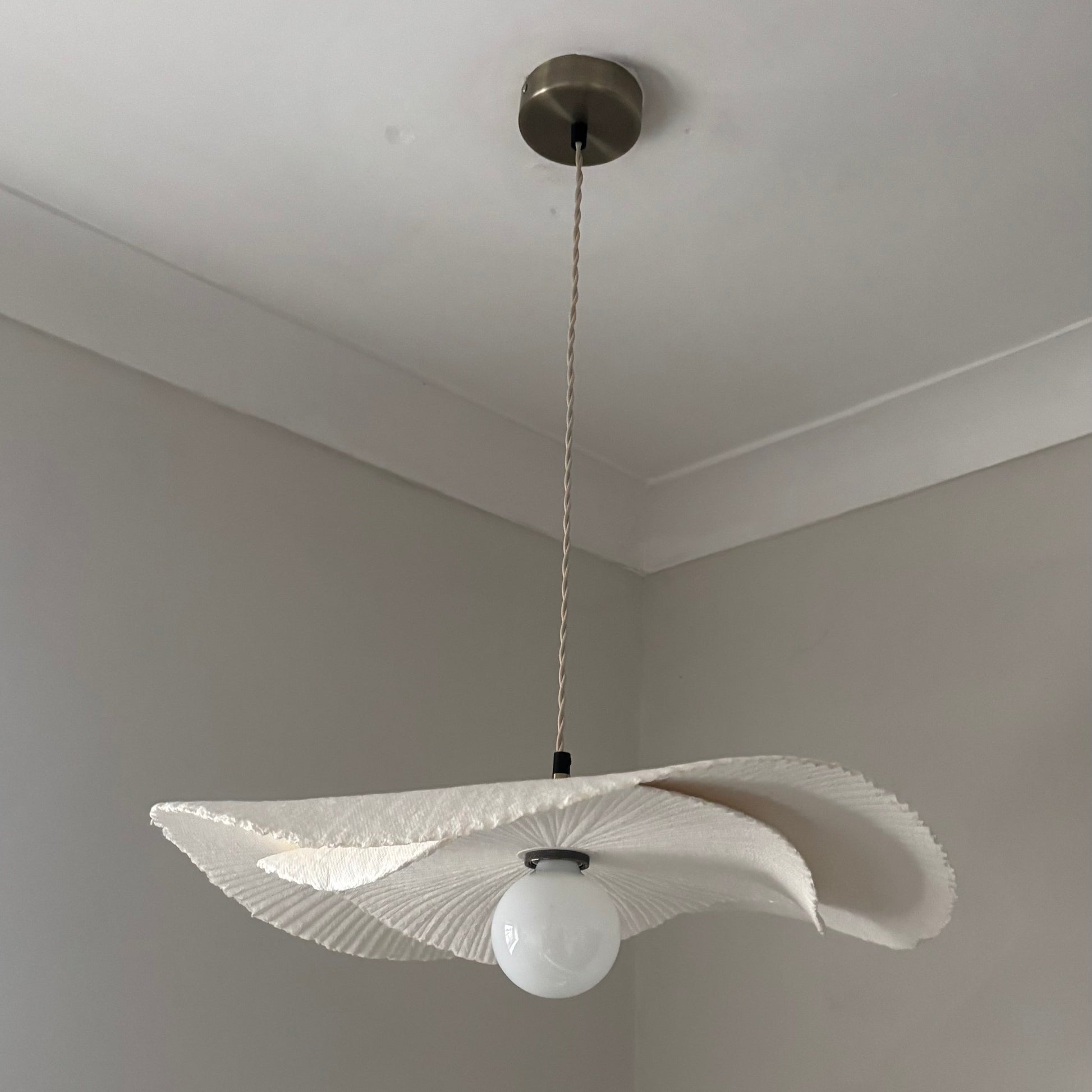 Modern pendant light with a unique design hanging from the ceiling.