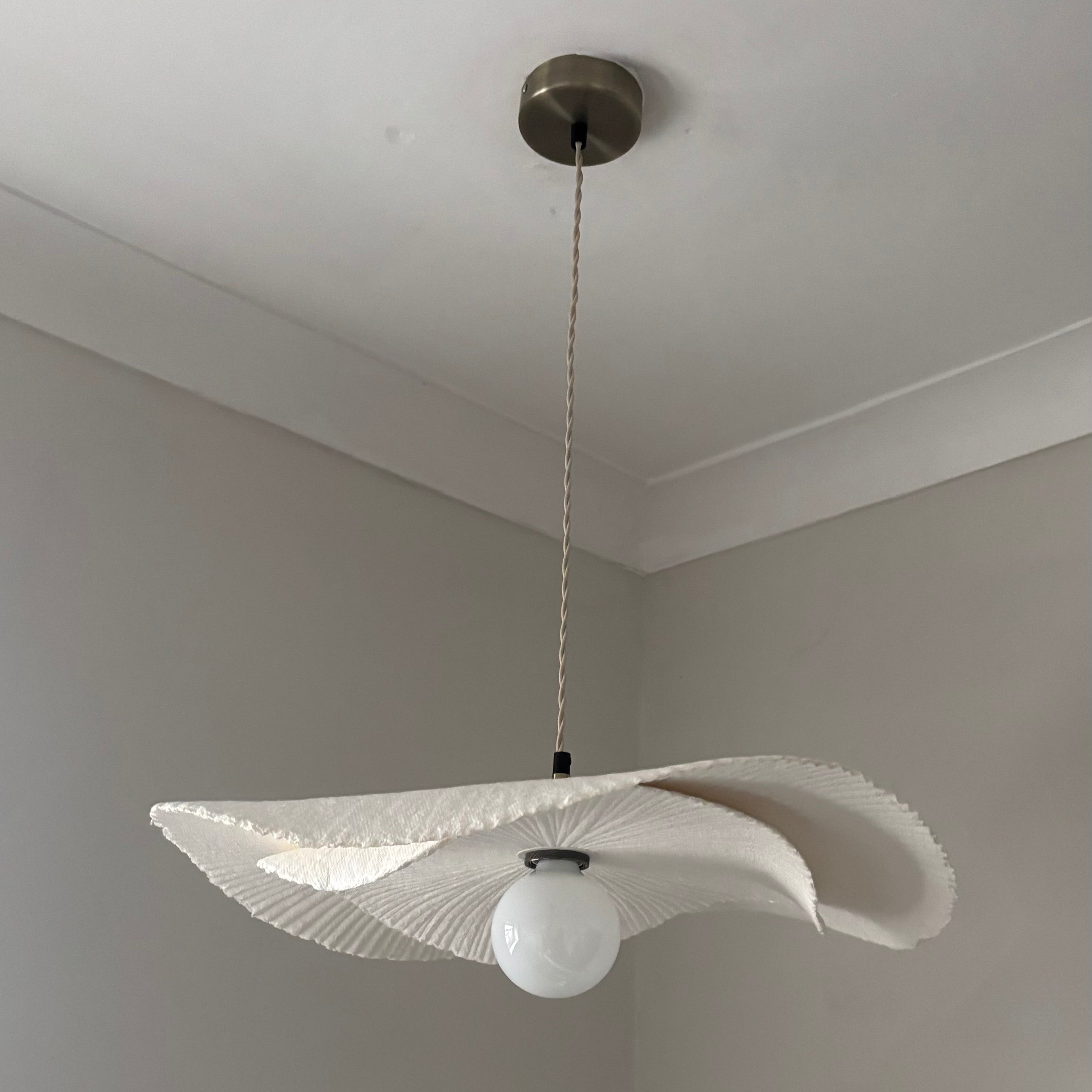 Modern pendant light with a unique design hanging from the ceiling.