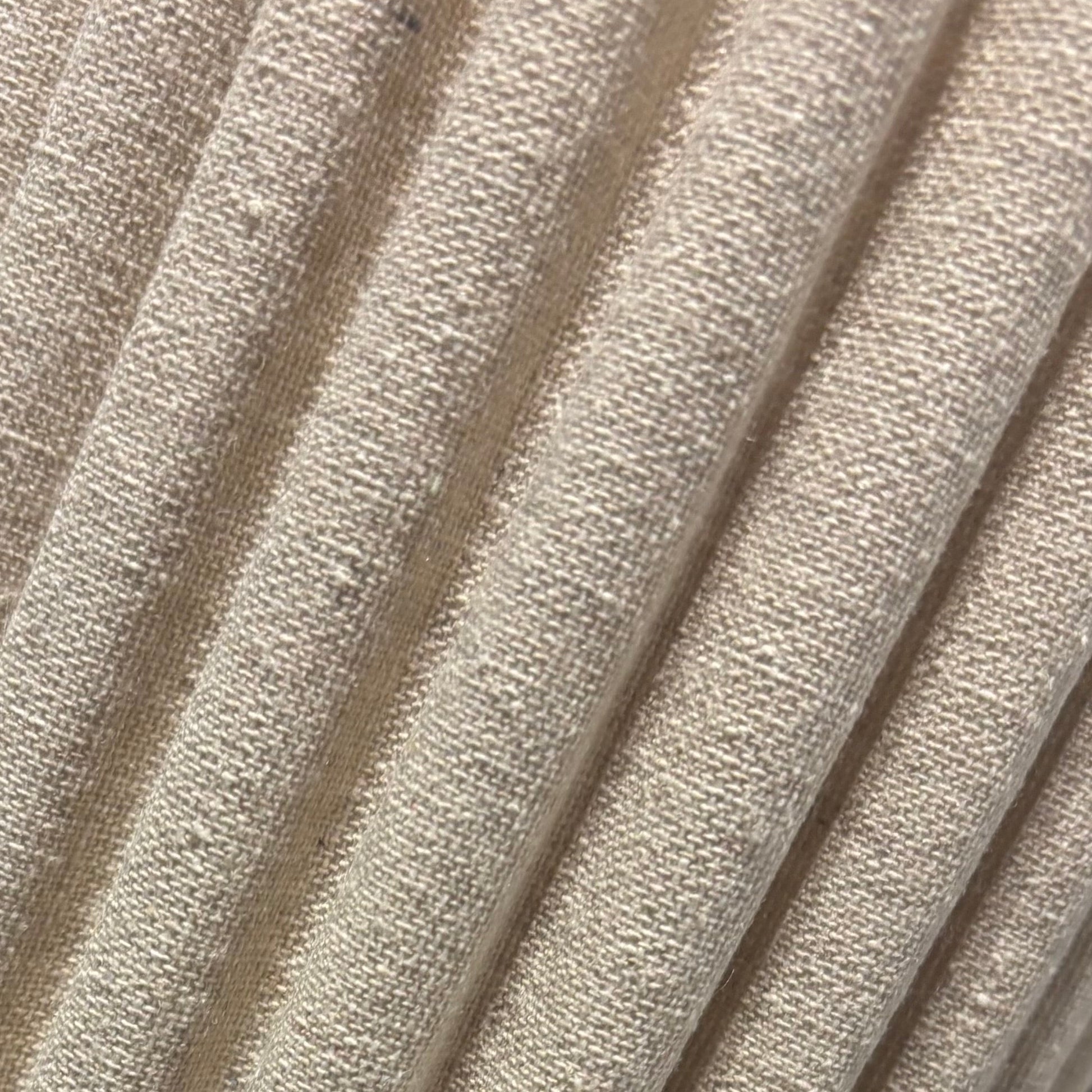 Close-up of a textured beige cylindrical object on a black surface