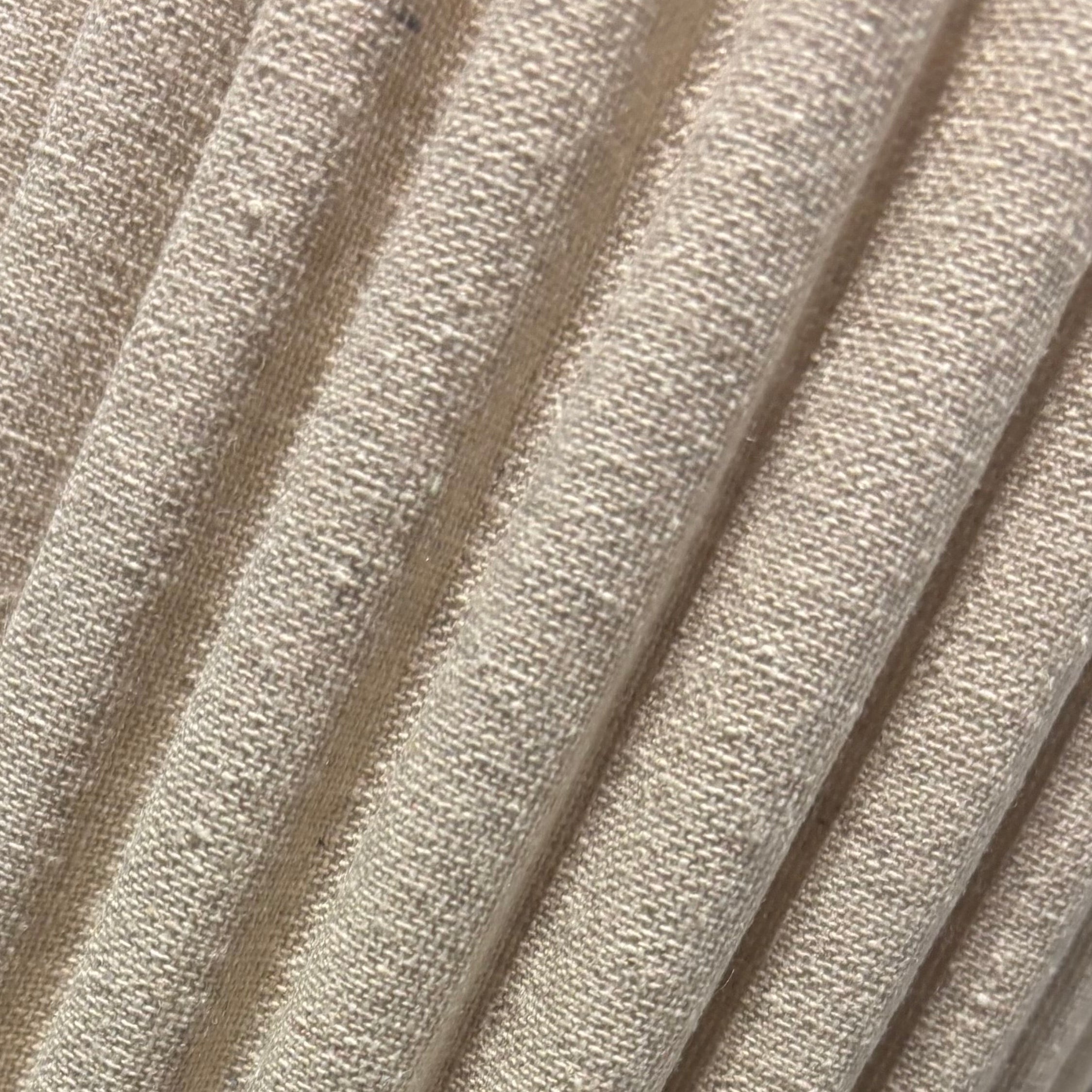 Close-up of a textured beige cylindrical object on a black surface