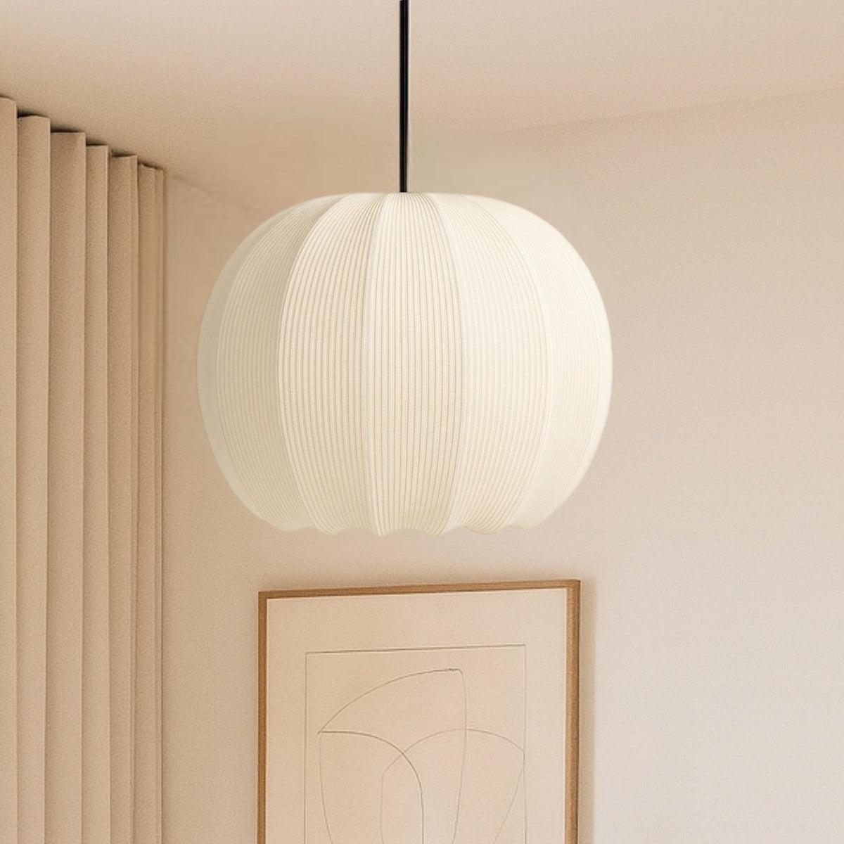 Modern bedroom interior with a pendant light, wall art, and a plant.