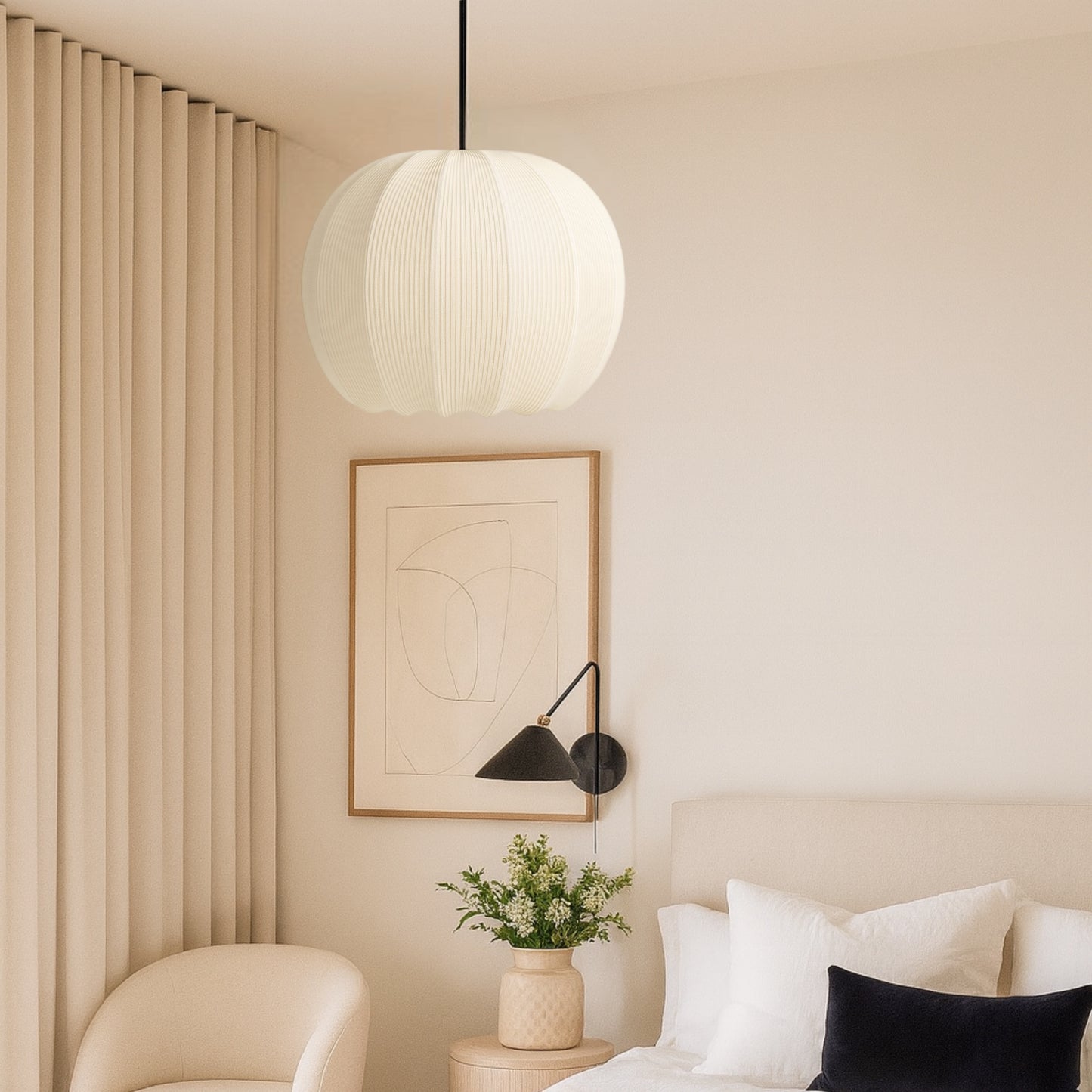 Modern bedroom interior with a pendant light, wall art, and a plant.